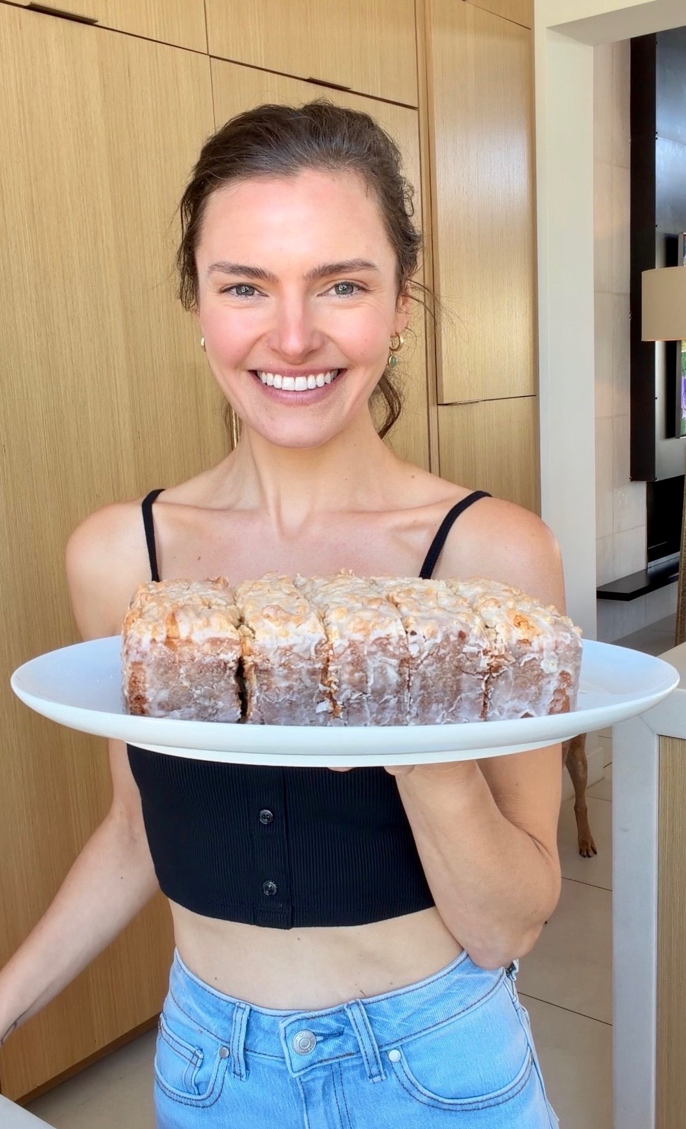Angela holding a sliced and glazed Old-Fashioned Donut Loaf